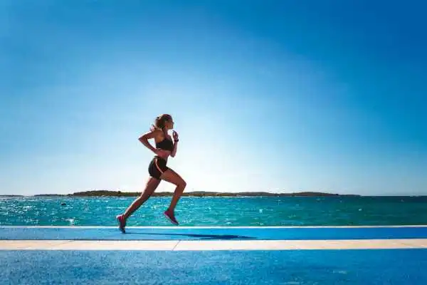 Woman running showing strong leg muscle Southam